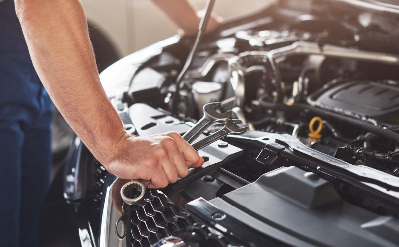 1741965324_muscularcarserviceworkerrepairingvehiclejpg.jpg